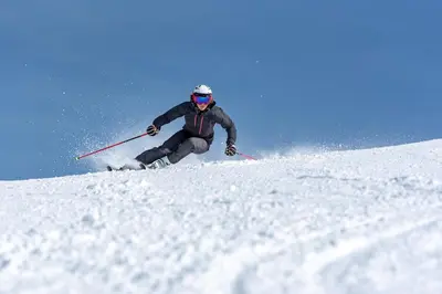 a man is skiing down a snow covered slope at Modern family cabin with ski in out, central location in Beitostølen in Beitostøl