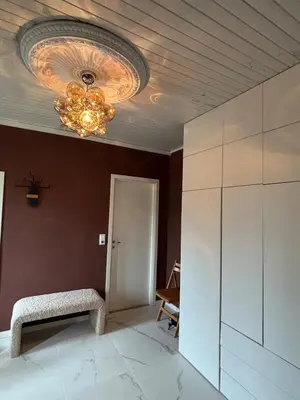 a room with a ceiling with a chandelier at Charming newly renovated house in city centre in Verdal