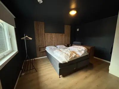 a bedroom with a bed in a black room at Charming newly renovated house in city centre in Verdal