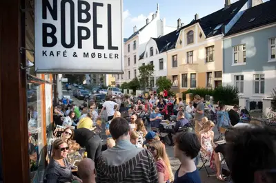 a large crowd of people walking down a street at Beautiful apartment in the heart of Bergen in Bergen