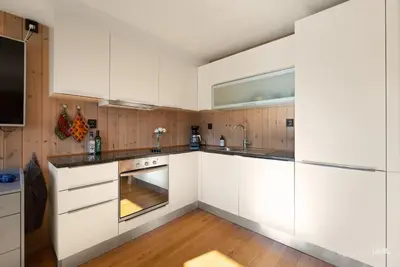 a kitchen with white cabinets and a sink at New! Stay close to Hardangervidda & Vøringsfossen in Eidfjord