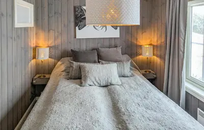 a bedroom with a large bed with two lamps at 2 Bedroom Lovely Apartment In Rjukan in Rjukan