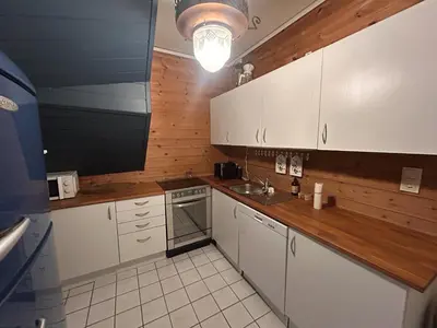 a kitchen with white cabinets and a sink at City apartment in Bergen in Bergen