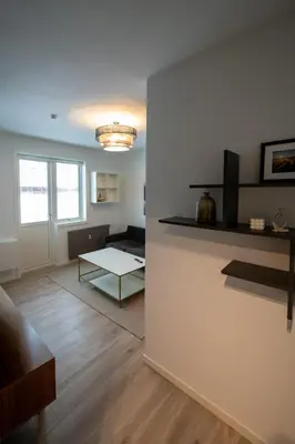 a living room with a couch and a table at Ultra central flat with balcony in Bergen