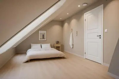 a bedroom with a bed and a white door at Toppleilighet på Sandviken med balkong in Bergen