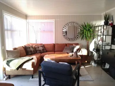 a living room with a couch and a table at Holiday home near all facilities in Grinde, Aksdal in Tysvær