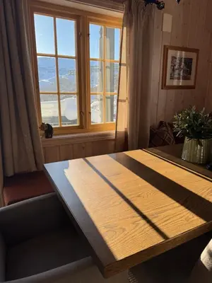 a wooden table in a room with a window at Cozy ski in&out cabin Hemsedal in Hemsedal