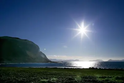 a shining star in the sky over a body of water at Alnes Gård in Ålesund