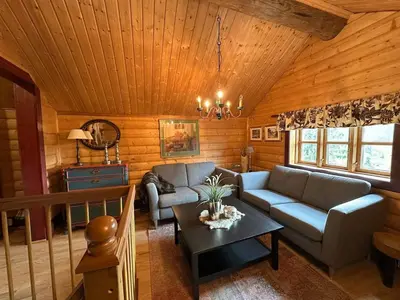 a living room with a couch and a table at Cosy cabin in Eggedal