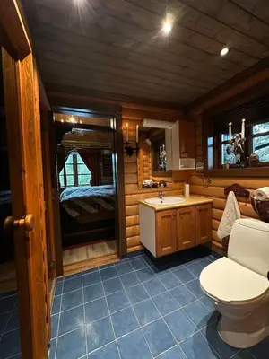 a bathroom with a toilet and a sink at Cosy cabin in Eggedal