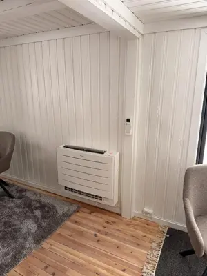 a room with a heater in the corner of a wall at Quiet detached house in Haukeli, modern and homey in Haukeligrend