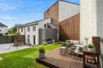 a small backyard with a wooden deck and a house at House 2 rooms in Trondheim