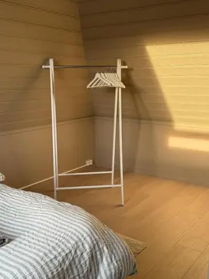 a room with a bed and a shelf in a attic at Cozy loft apartment in the heart of Bergen in Bergen