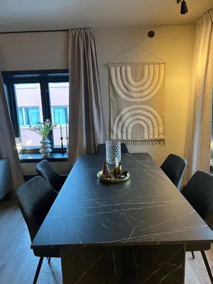 a dining room with a blue table and chairs at Great apartment in the center of Ålesund in Ålesund