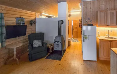 a kitchen with a stove in the middle of a room at Nice Home In Rendalen With House A Panoramic View in Rendalen