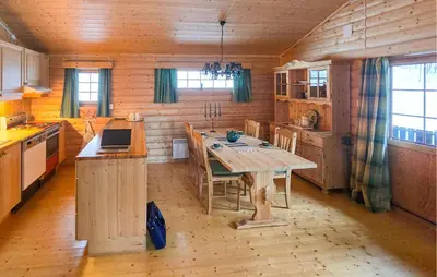 a kitchen with a wooden table in a cabin at Nice Home In Rendalen With House A Panoramic View in Rendalen