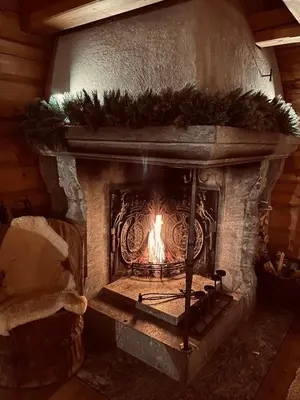 a stone fireplace with a fire in it at Skogstad Lodge, Hemsedal in Hemsedal
