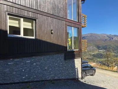 a person standing in a window of a house at Skarsnuten Panorama 61, Hemsedal in Hemsedal