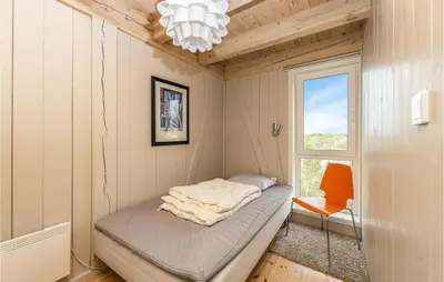 a small room with a bed and a window at 4 Bedroom Nice Home In Tustna in Leira