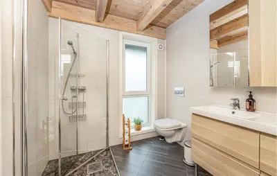 a bathroom with a shower and a toilet and a sink at 4 Bedroom Nice Home In Tustna in Leira