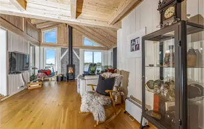 a living room with a clock on the wall at 4 Bedroom Nice Home In Tustna in Leira