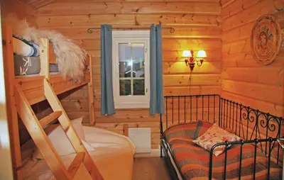 a log cabin bedroom with a bunk bed and a window at Holiday Home Hol With A Fireplace 02 in Hovet