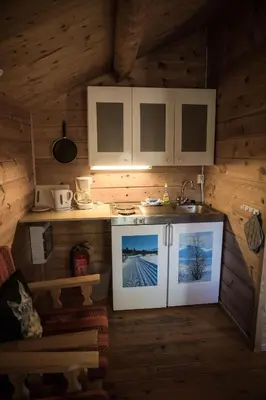 a kitchen with a stove and a sink in a cabin at Sjodalen Hyttetun og Camping in Stuttgongfossen