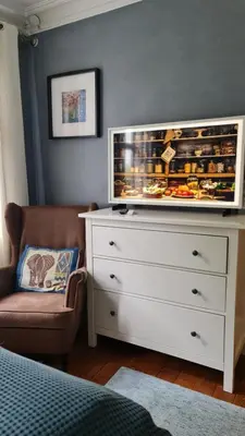 a bedroom with a white dresser and a couch and a chair at Amunds Apartment in Bergen