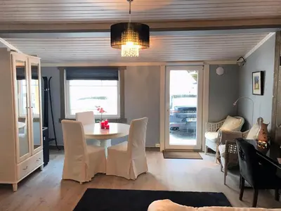 a dining room with a table and chairs at Kvamseter Lodge in Kvamseter