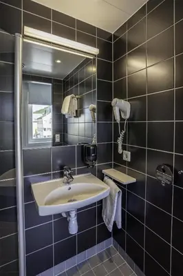 a bathroom with a sink and a mirror at Prize by Radisson, Solheimsviken Bergen in Bergen