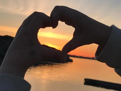a person making a heart shape with their hands at Lauvøy Feriesenter in Askøy