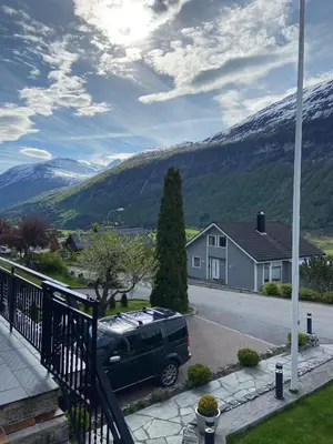 a van parked in a driveway in front of a house at Aarnes house Stryn in Stryn