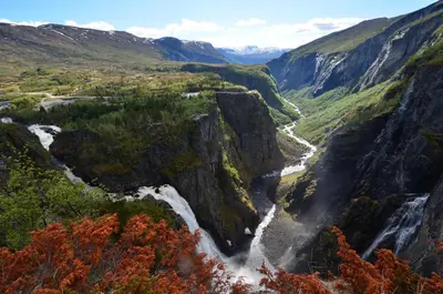 a view of a waterfall in a canyon at Fossli Hotel in Eidfjord