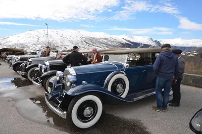 a group of old cars parked in a parking lot at Fossli Hotel in Eidfjord