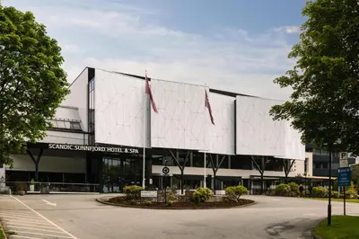 a building with two flags in front of it at Scandic Sunnfjord Hotel & Spa in Førde