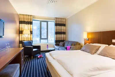 a hotel room with a large bed and a desk at Scandic Sunnfjord Hotel & Spa in Førde