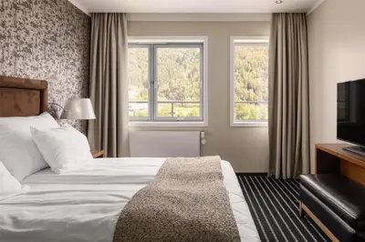 a hotel room with a bed and a television at Scandic Sunnfjord Hotel & Spa in Førde