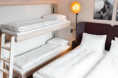 two bunk beds in a room with a lamp at Scandic Sunnfjord Hotel & Spa in Førde