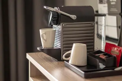 a coffee maker with two cups on a table at Scandic Lillehammer Hotel in Lillehammer