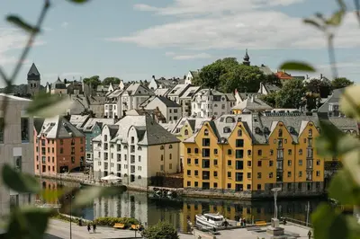 a group of buildings in a city next to a river at Hotel Brosundet in Ålesund