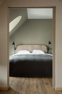 a bedroom with a large bed and two lamps at Hotel Brosundet in Ålesund