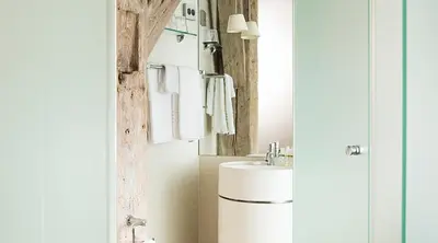 a bathroom with a sink and a mirror at Hotel Brosundet in Ålesund