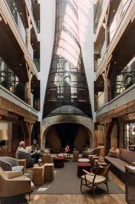 a large lobby with couches and chairs in a building at Hotel Brosundet in Ålesund