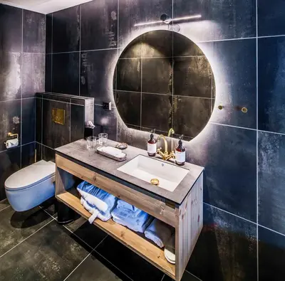 a bathroom with a sink and a mirror at Villa Vågå - by Classic Norway Hotels in Vågåmo