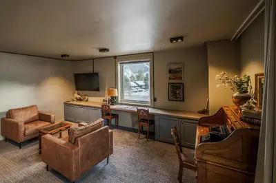 a living room with a couch and a desk at Villa Vågå - by Classic Norway Hotels in Vågåmo