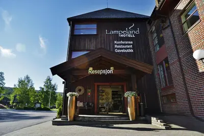 a building with a sign on the front of it at Lampeland Hotel in Lampeland