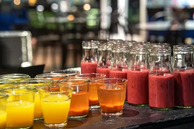 a group of glasses of different colored drinks on a table at Thon Hotel Kristiansund in Kristiansund