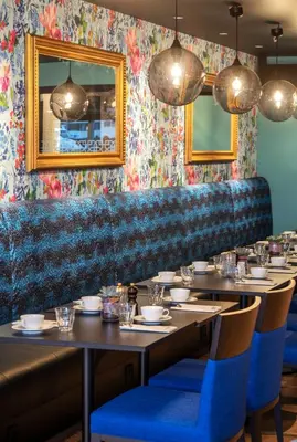 a dining room with tables and blue chairs at Thon Hotel Kristiansund in Kristiansund