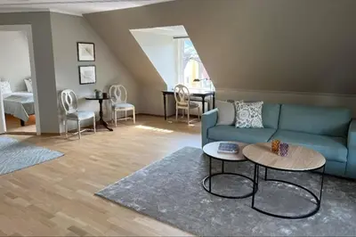 a living room with a blue couch and a table at Hotel Park Bergen in Bergen
