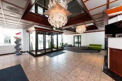 a lobby with two chandeliers in a building at Thon Hotel Victoria Hamar in Hamar